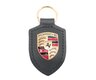 Porte-clés Porsche vert chêne métallisé avec écusson Porsche.